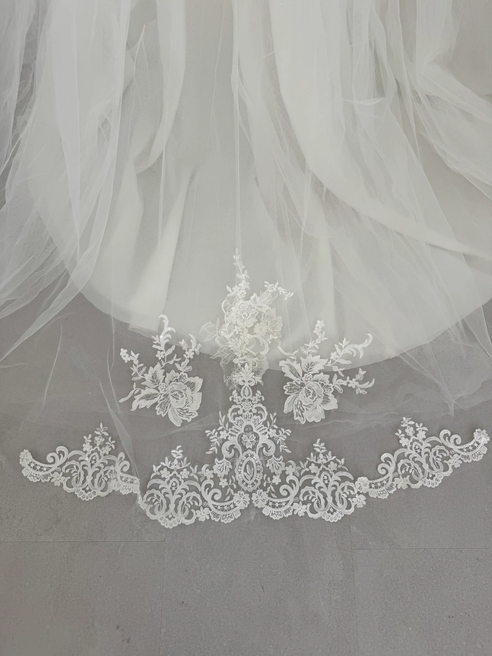 Robe de mariée Anais en promotion, détail de la traîne bordée de dentelle